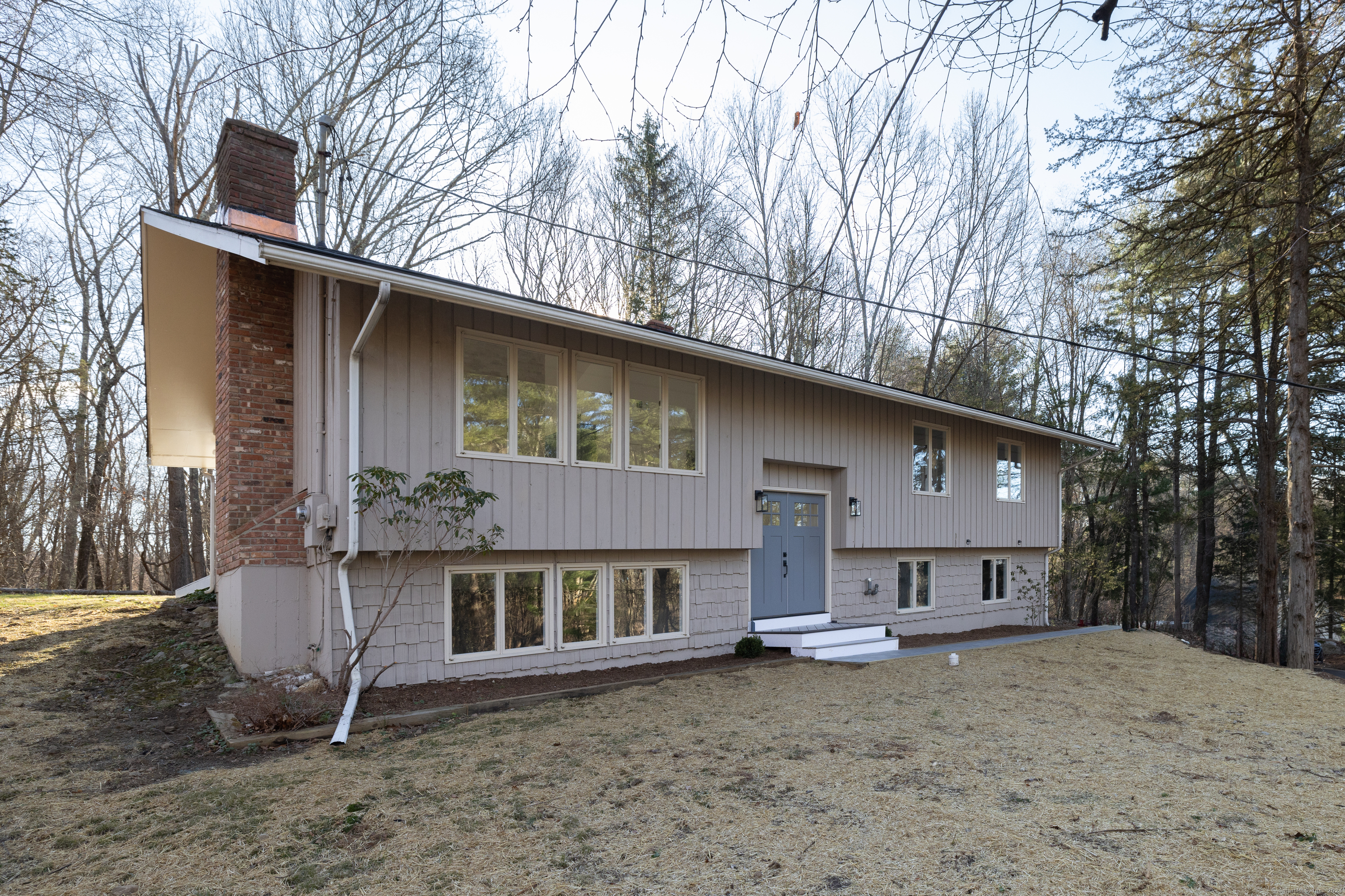 a house that has a tree in front of it