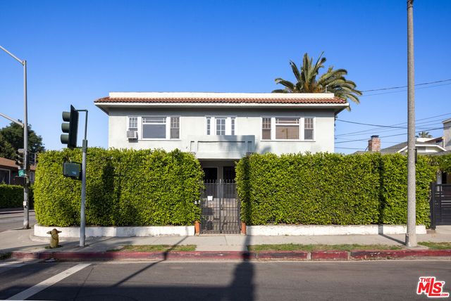 a view of a house with a backyard and a chair