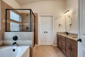 a bathroom with a tub sink and mirror