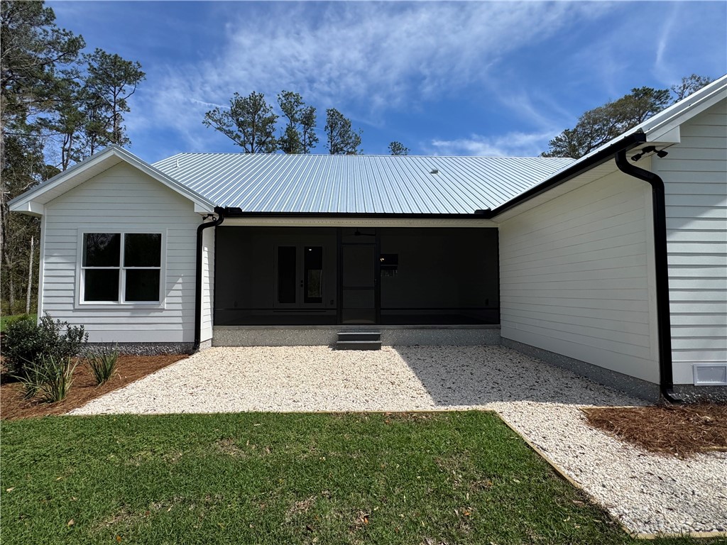 194 Piney Bluff Road Waverly, GA 31565 - Photo 5 of 36 Screened in back porch with rock patio and rock