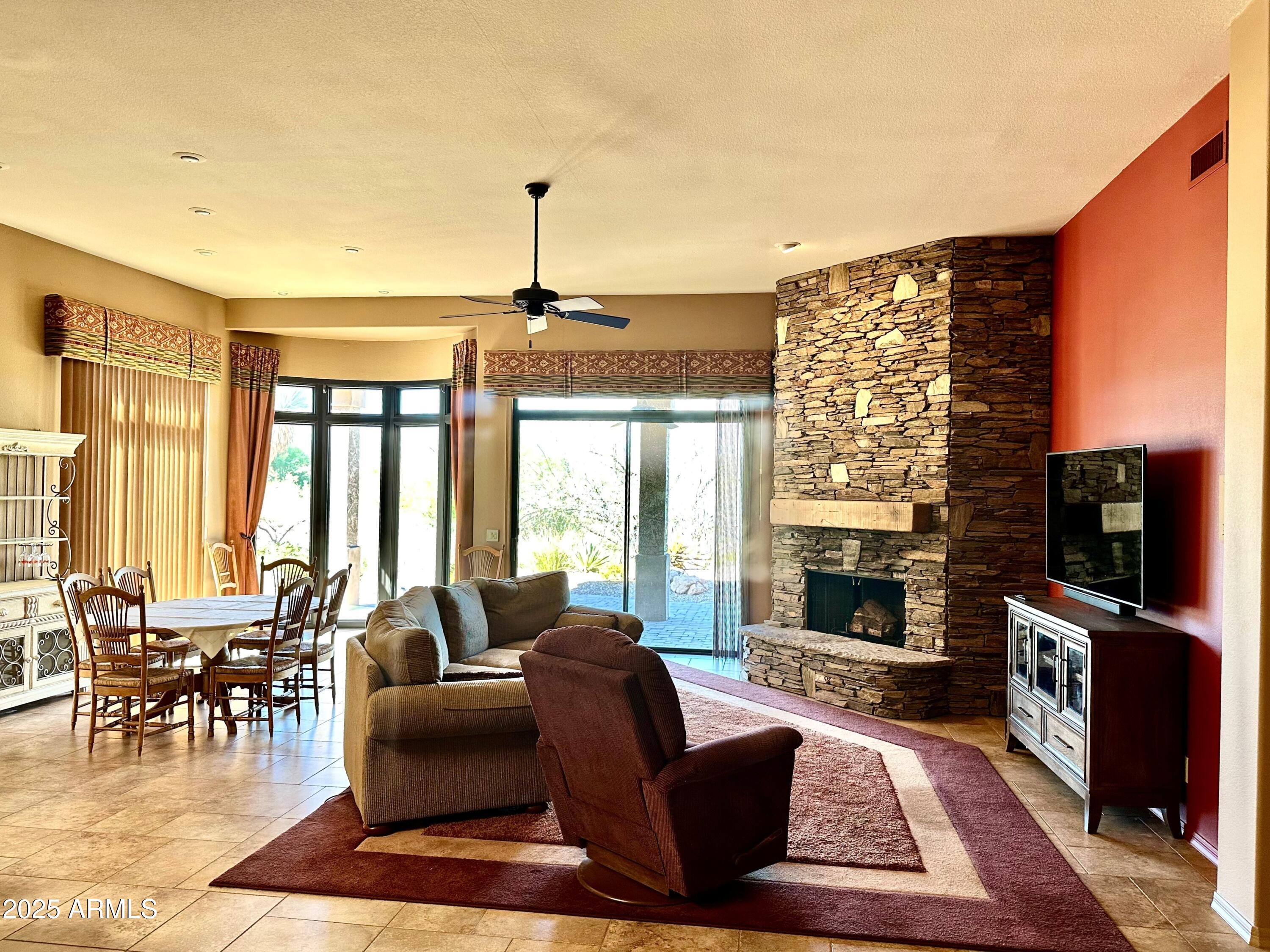 18626 Amarado Circle Rio Verde, AZ 85263 - Photo 2 of 19 a living room with fireplace furniture and a flat screen tv