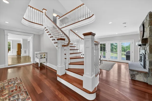 a view of entryway and hall with wooden floor