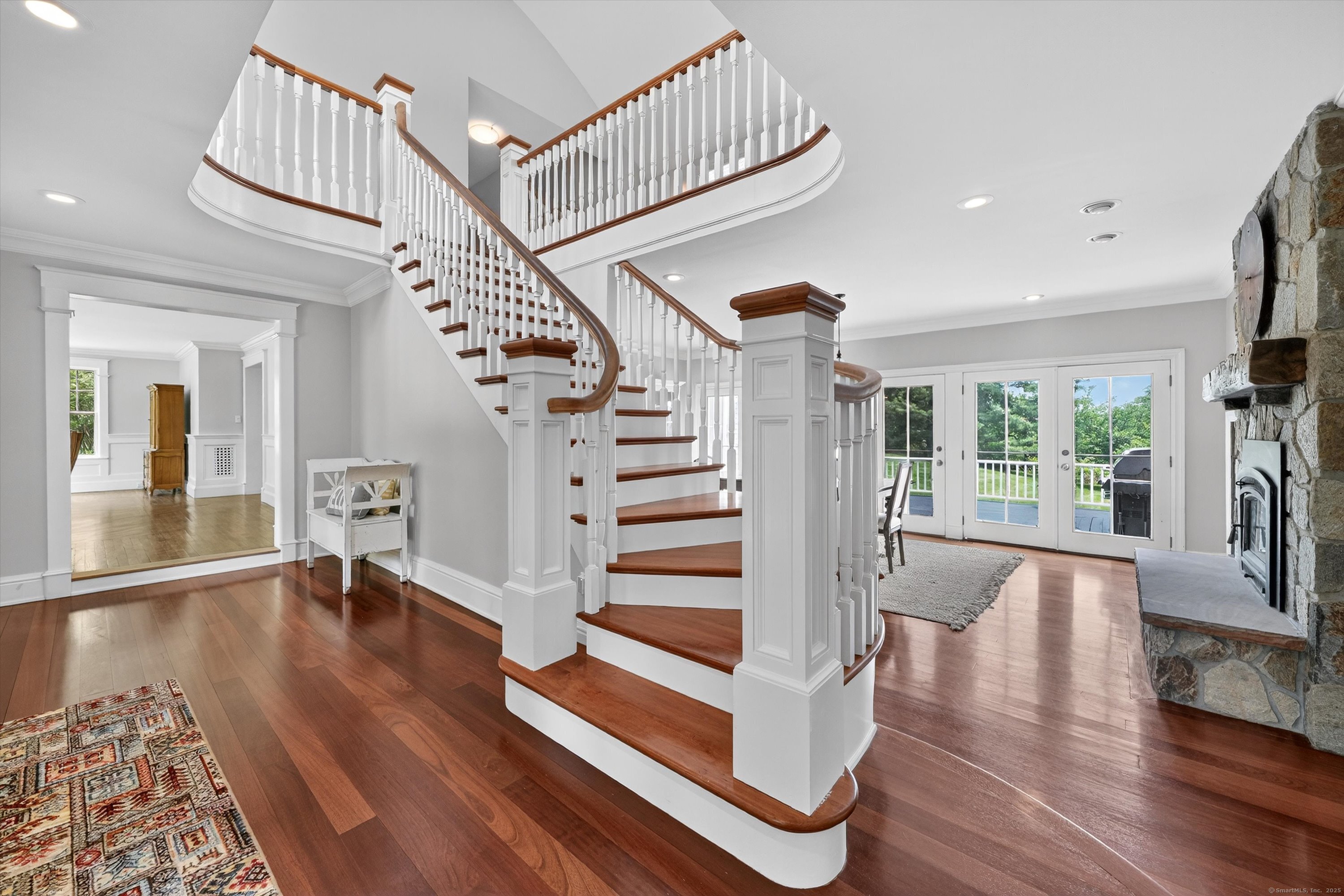 a view of entryway and hall with wooden floor
