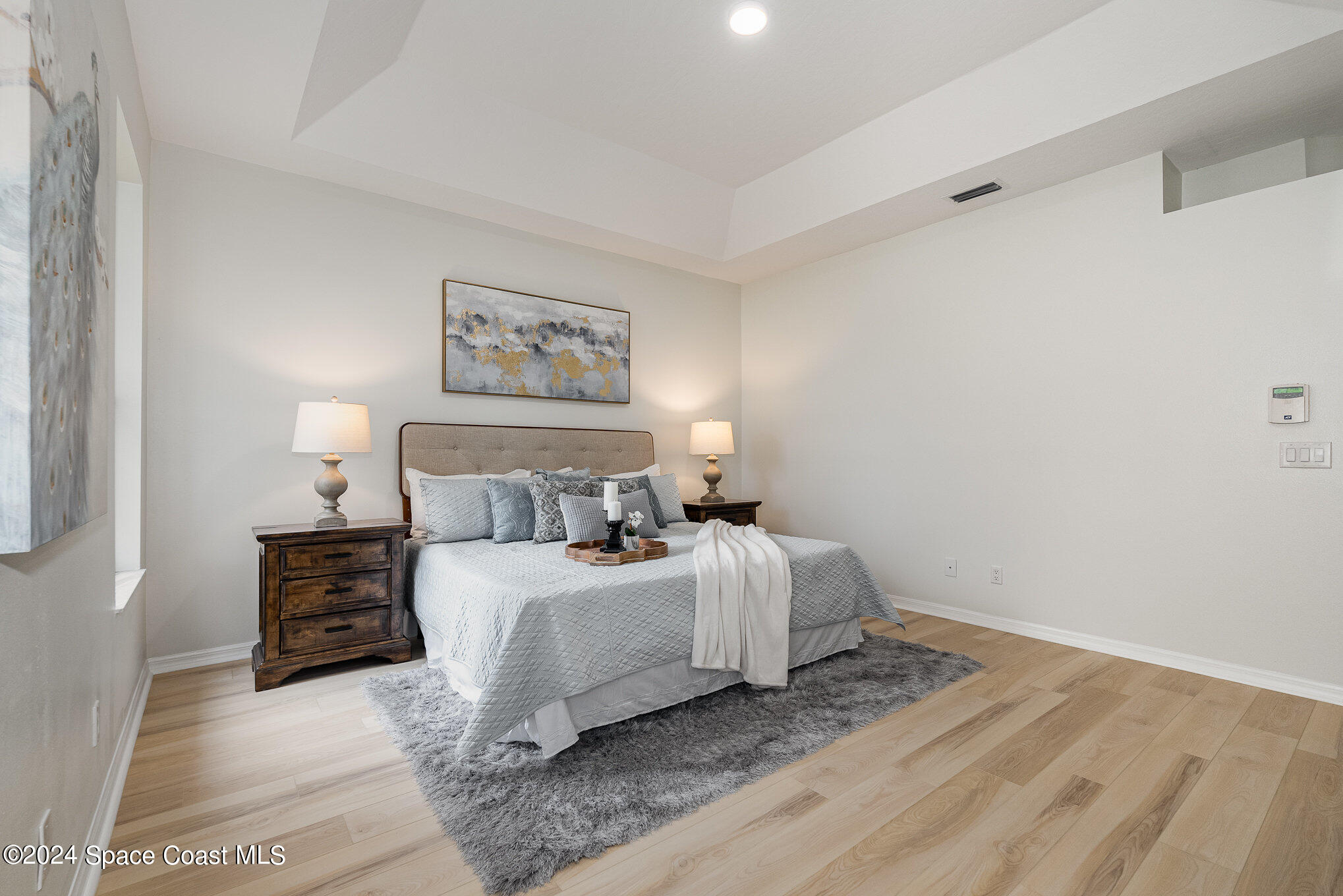 511 Shell Cove Drive Melbourne, FL 32940 - Photo 13 of 31 a bedroom with a bed and a painting on the wall