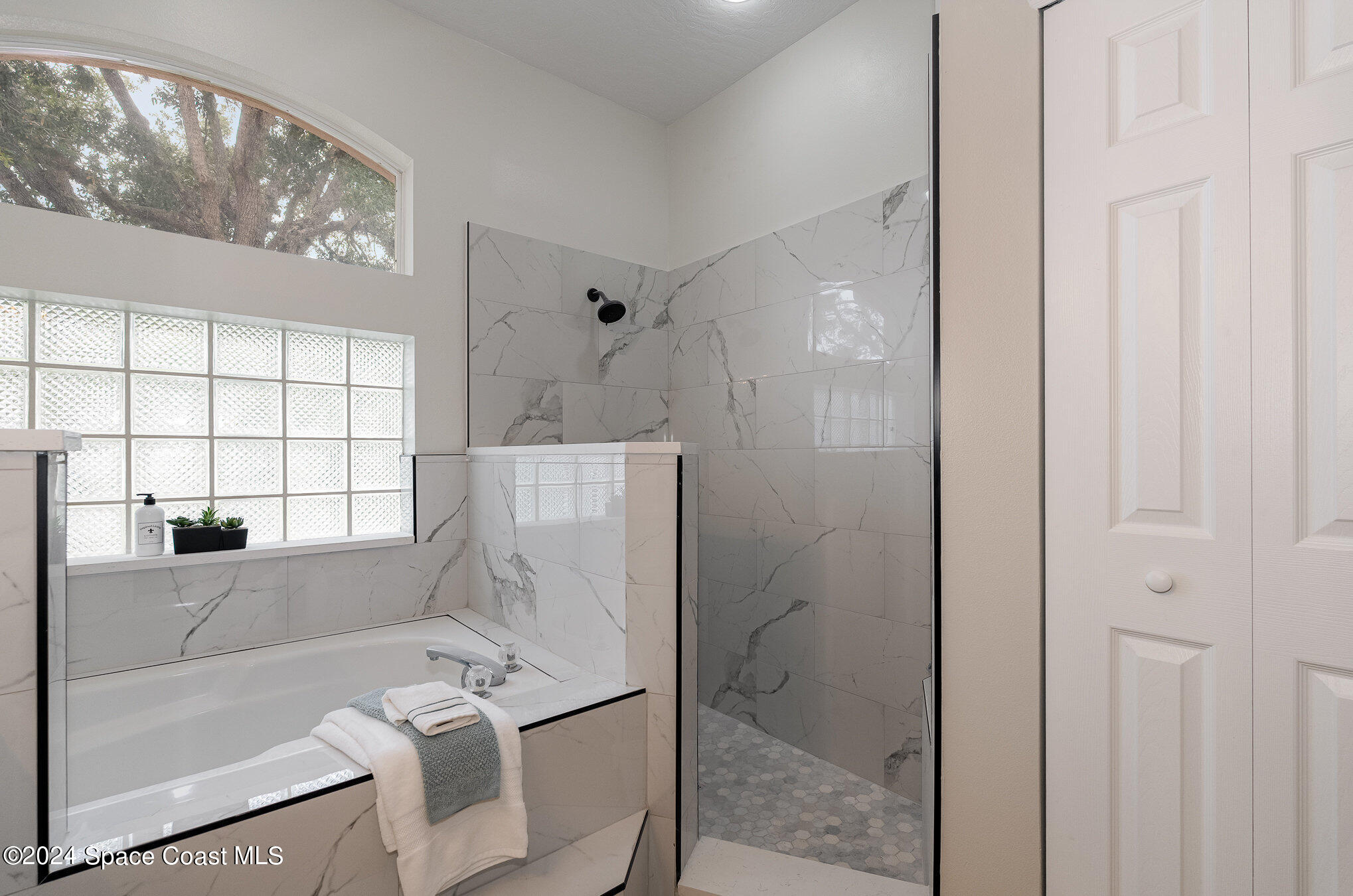 511 Shell Cove Drive Melbourne, FL 32940 - Photo 16 of 31 a bathroom with a bathtub and a shower