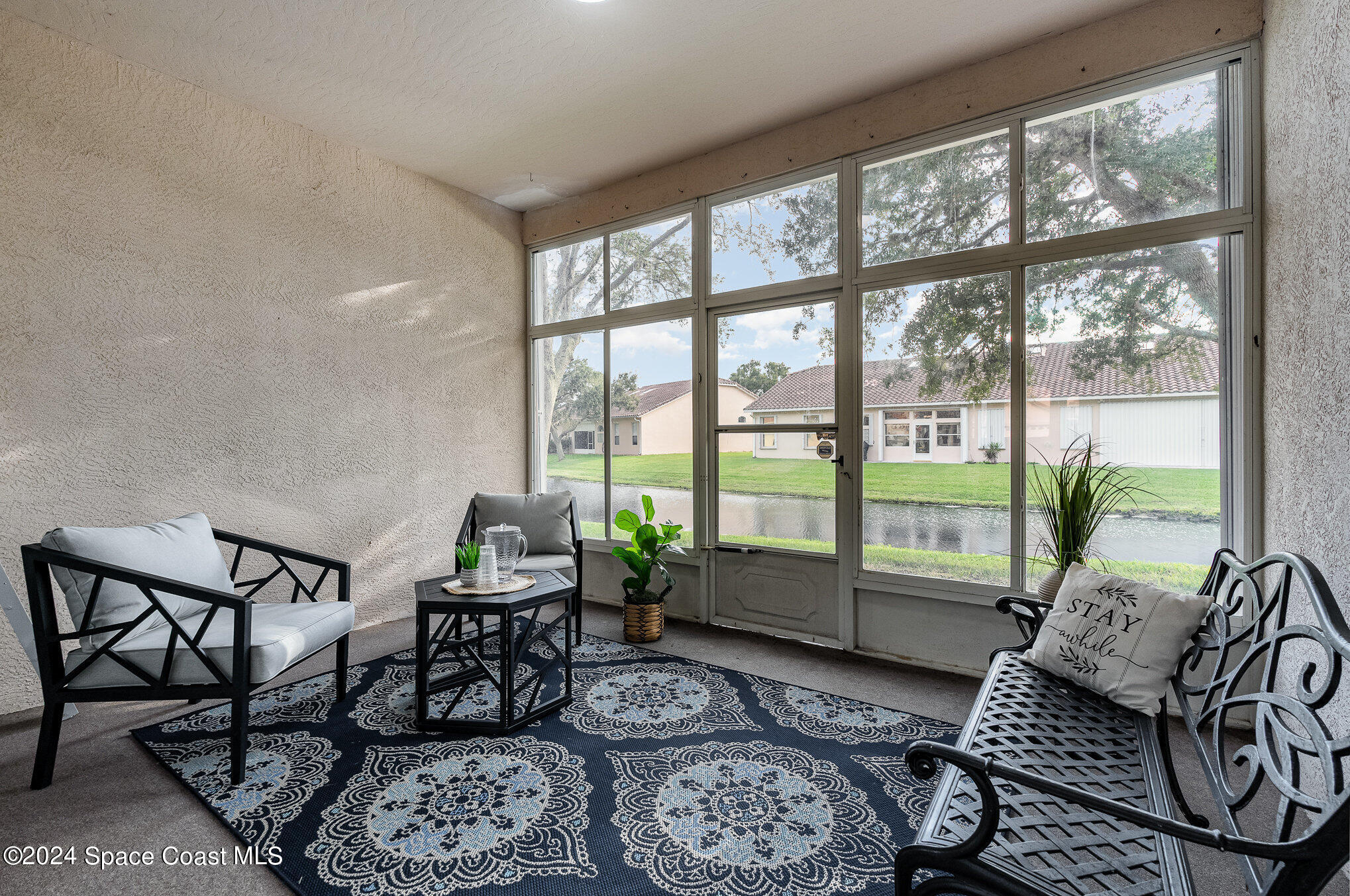 511 Shell Cove Drive Melbourne, FL 32940 - Photo 22 of 31 a living room with furniture and a large window