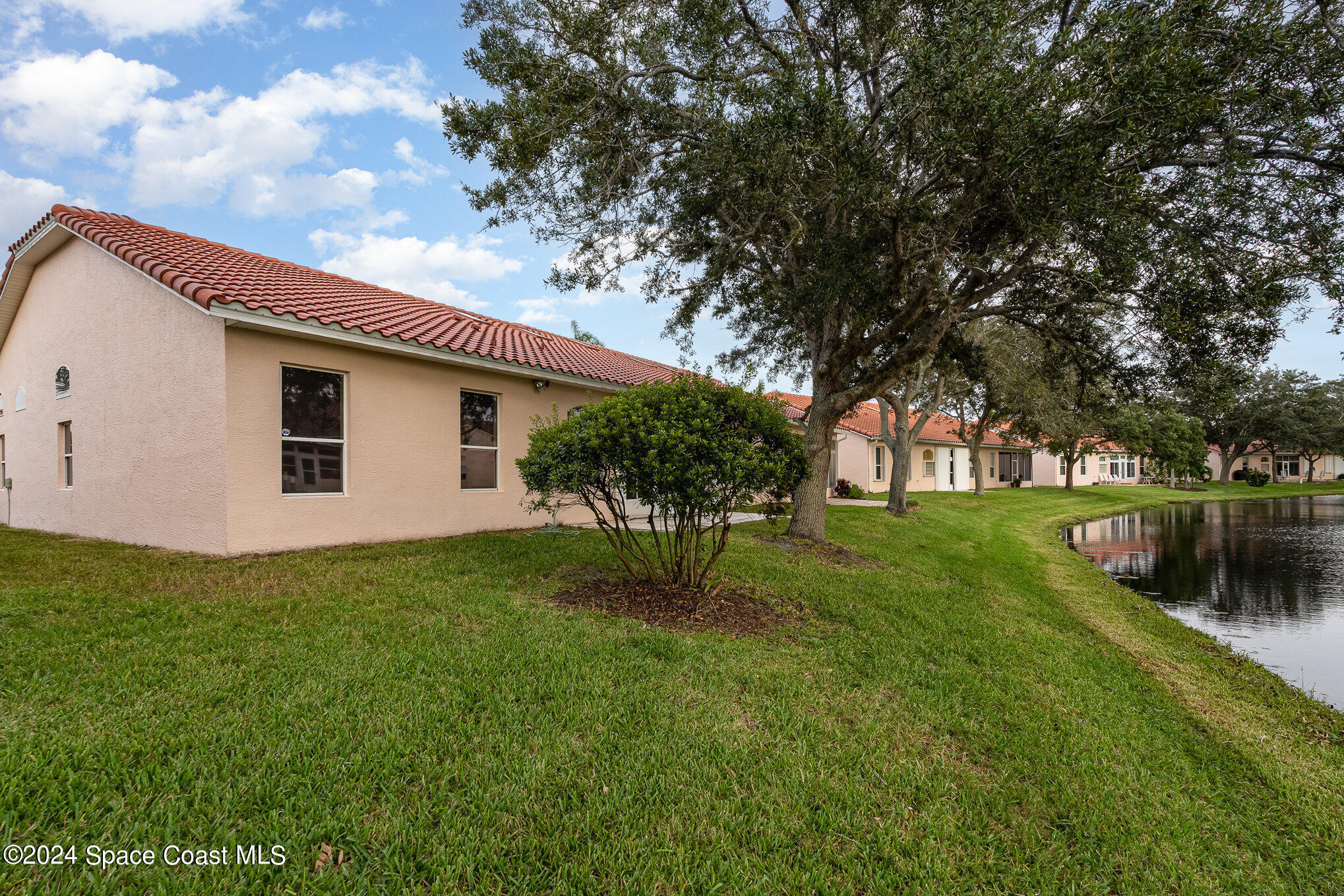 511 Shell Cove Drive Melbourne, FL 32940 - Photo 23 of 31 a backyard of a house with lots of green space and lake view