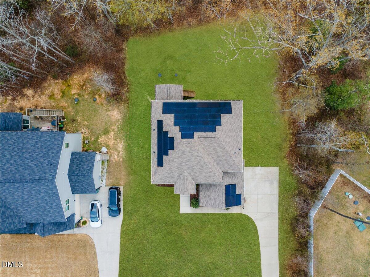 7804 Charters End Street Willow Spring, NC 27592 - Photo 41 of 43 an aerial view of a house with swimming pool and large trees