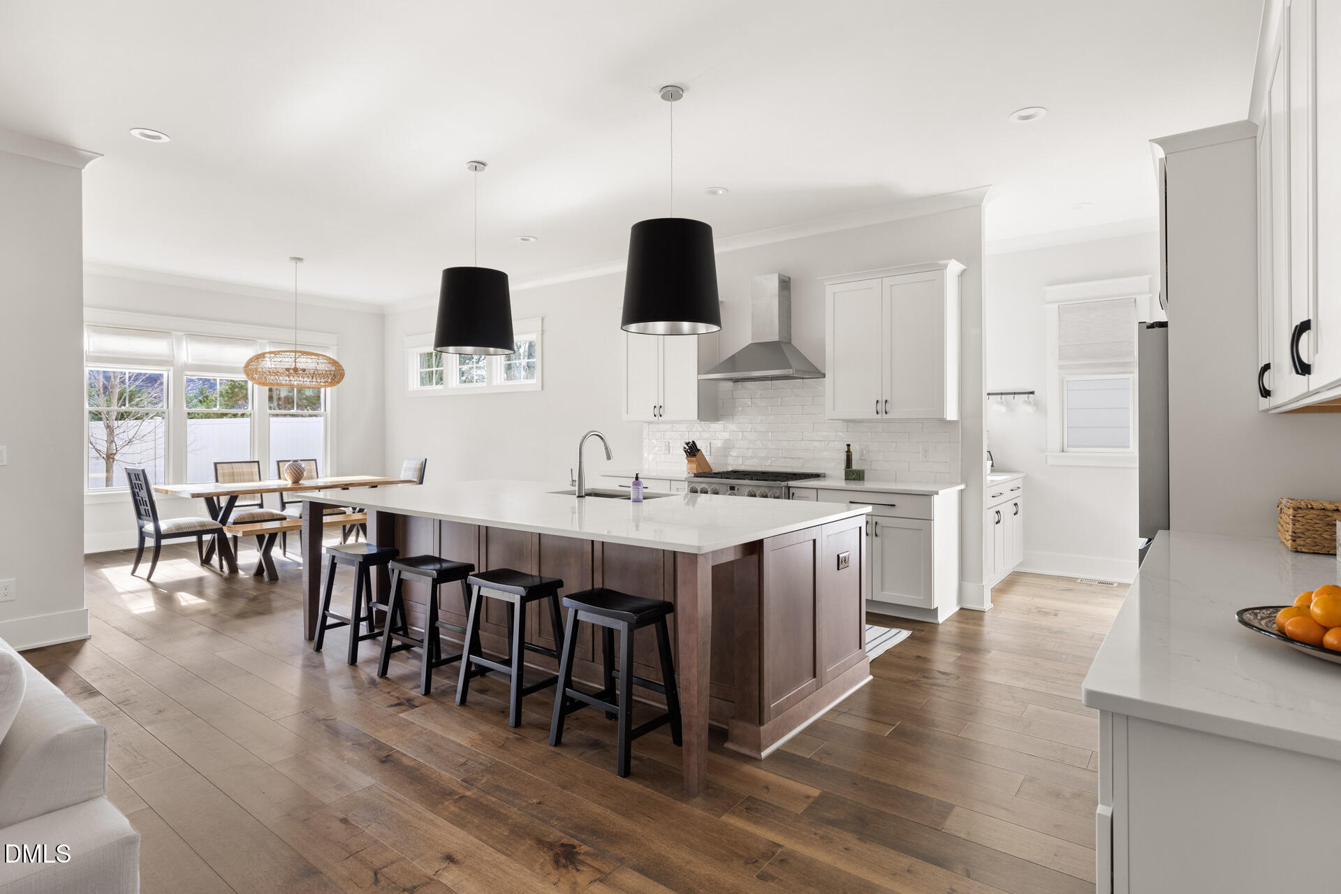 3025 Eden Harbor Court Raleigh, NC 27613 - Photo 12 of 44 a open kitchen with stainless steel appliances granite countertop a stove top oven a sink a dining table and chairs with wooden floor