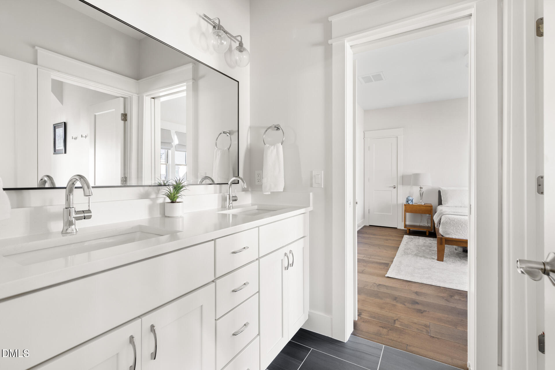 3025 Eden Harbor Court Raleigh, NC 27613 - Photo 31 of 44 a en suite bathroom with 2 sink flowerpot and a mirror