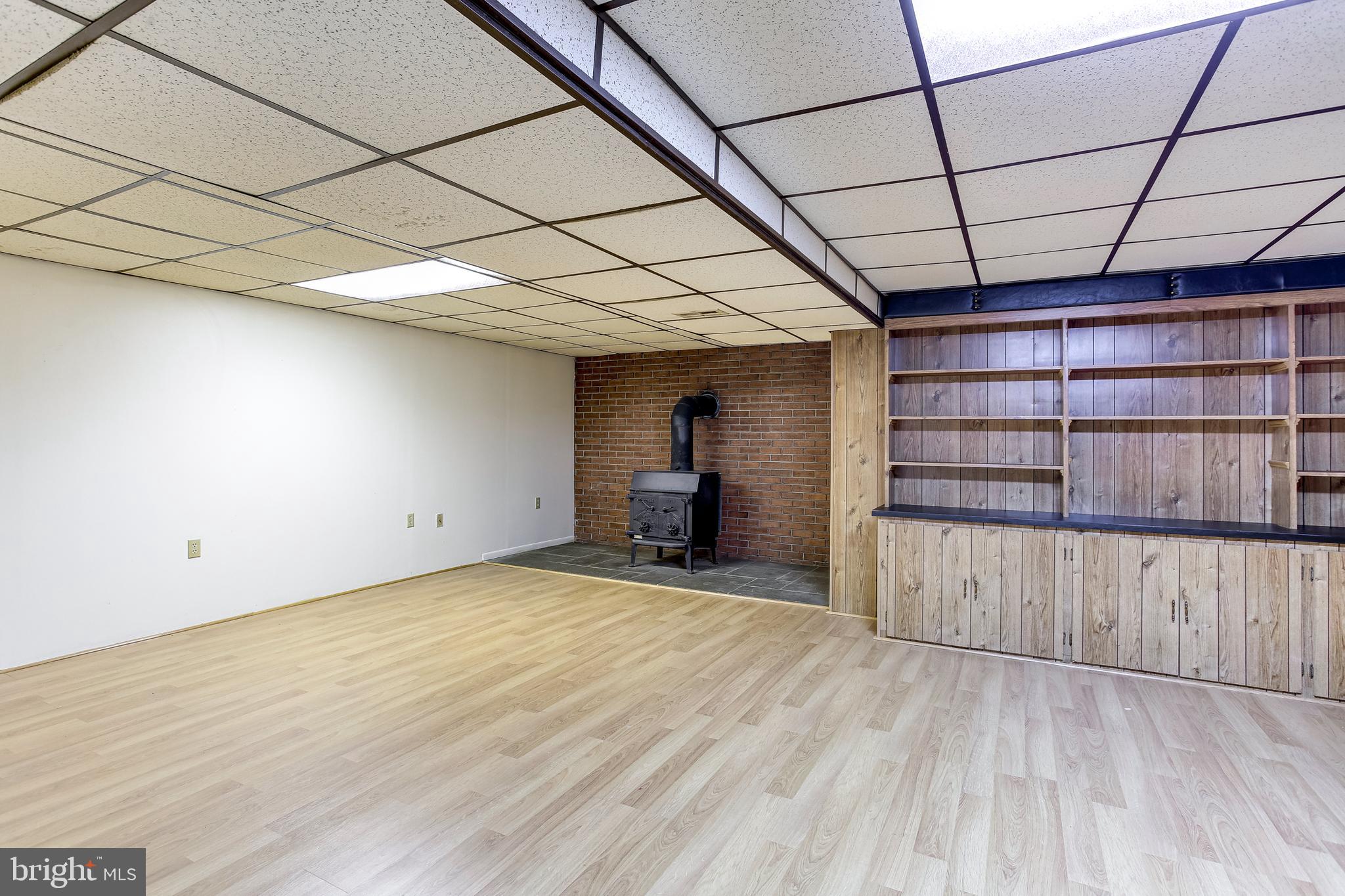 1519 Marsha Road Baltimore, MD 21227 - Photo 25 of 36 Lower Level Family Room w/ Wood Stove & Built-ins