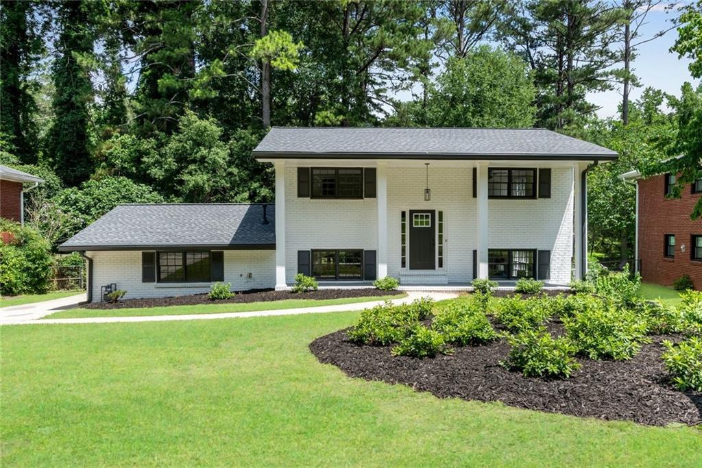 2550 Laurel Ridge Drive Decatur, GA 30033 - Photo 1 of 1 a front view of a house with a yard and garage