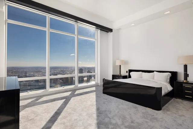 a view of a hall with wooden floor and windows