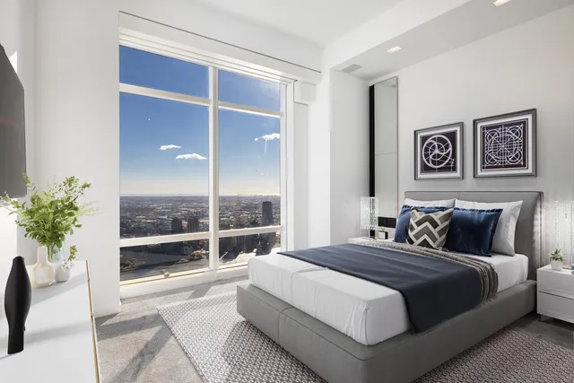 a bedroom with a bed and balcony view