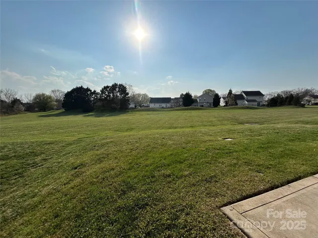 a view of a field with an ocean view