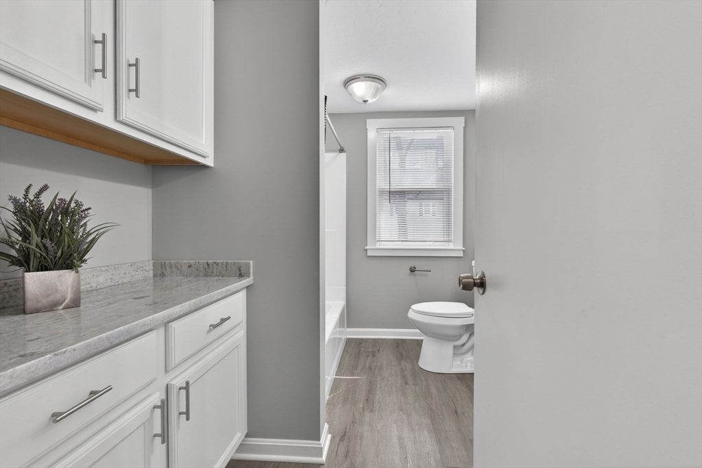 41 Clinton Street Marlborough, MA 01752 - Photo 15 of 26 a bathroom with a toilet a sink and mirror