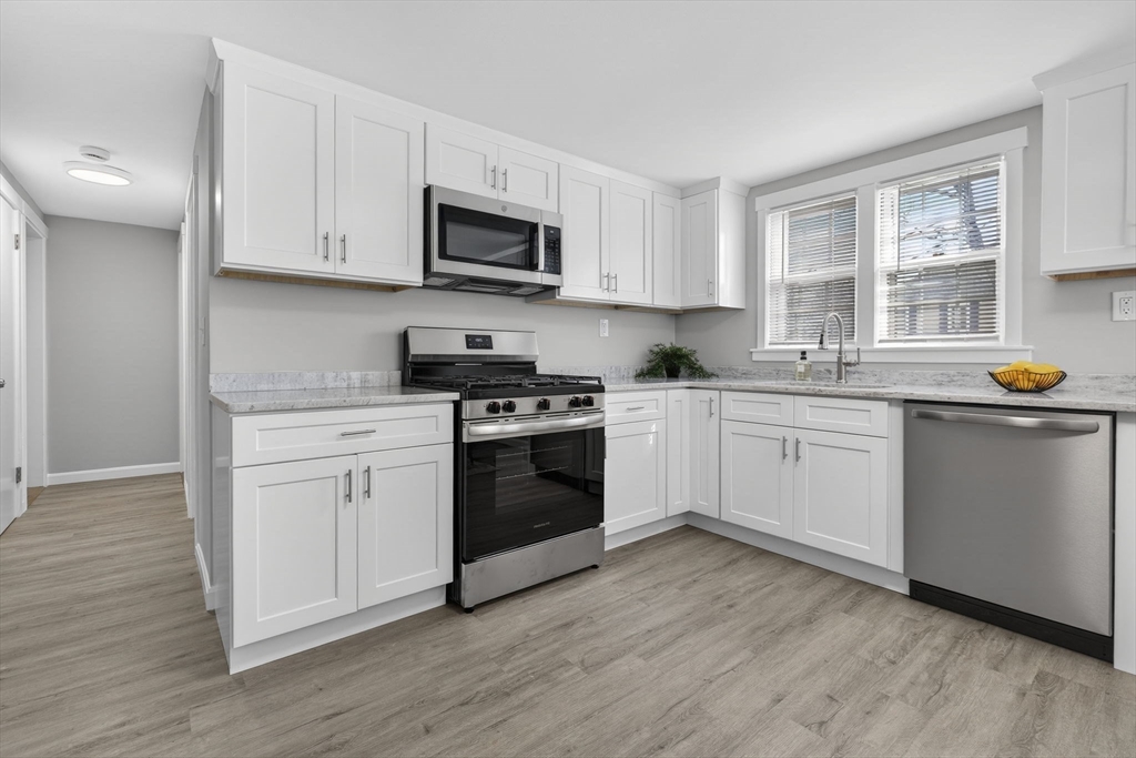 41 Clinton Street Marlborough, MA 01752 - Photo 7 of 26 a kitchen with white cabinets stainless steel appliances and sink