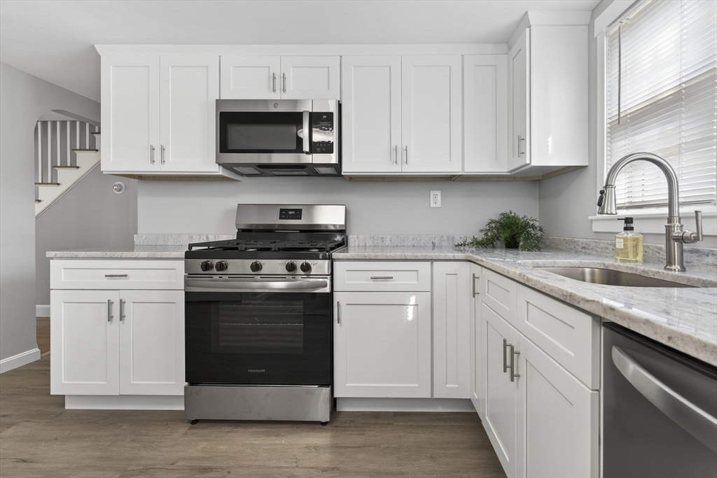 41 Clinton Street Marlborough, MA 01752 - Photo 8 of 26 a kitchen with white cabinets and stainless steel appliances