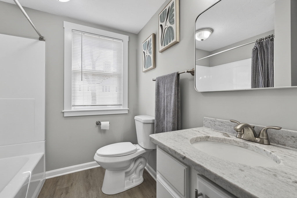 41 Clinton Street Marlborough, MA 01752 - Photo 10 of 26 a bathroom with a granite countertop sink toilet and mirror