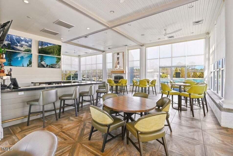 200 Regency Rdg Drive Apex, NC 27539 - Photo 25 of 39 a dining room with furniture a floor to ceiling window and chairs