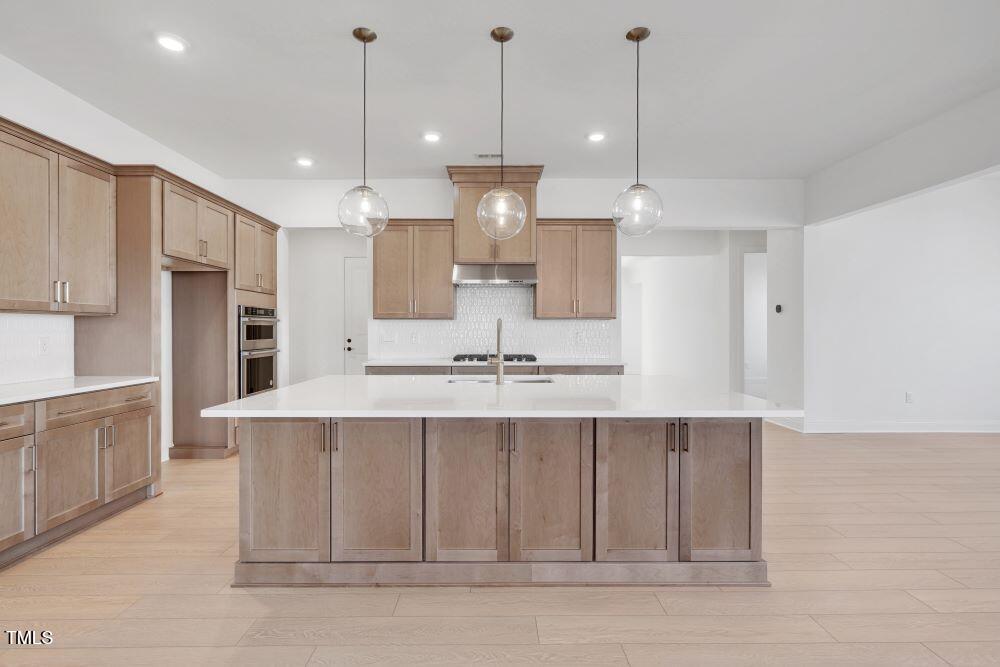 200 Regency Rdg Drive Apex, NC 27539 - Photo 2 of 39 a view of a kitchen with kitchen island a sink stainless steel appliances and cabinets