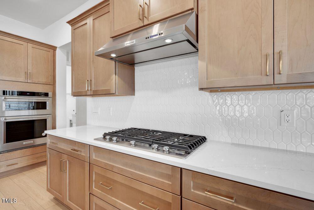 200 Regency Rdg Drive Apex, NC 27539 - Photo 3 of 39 a kitchen with stainless steel appliances a stove and a refrigerator