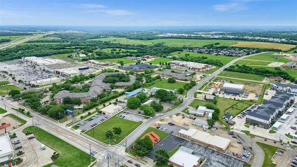 an aerial view of residential houses with outdoor space and river view