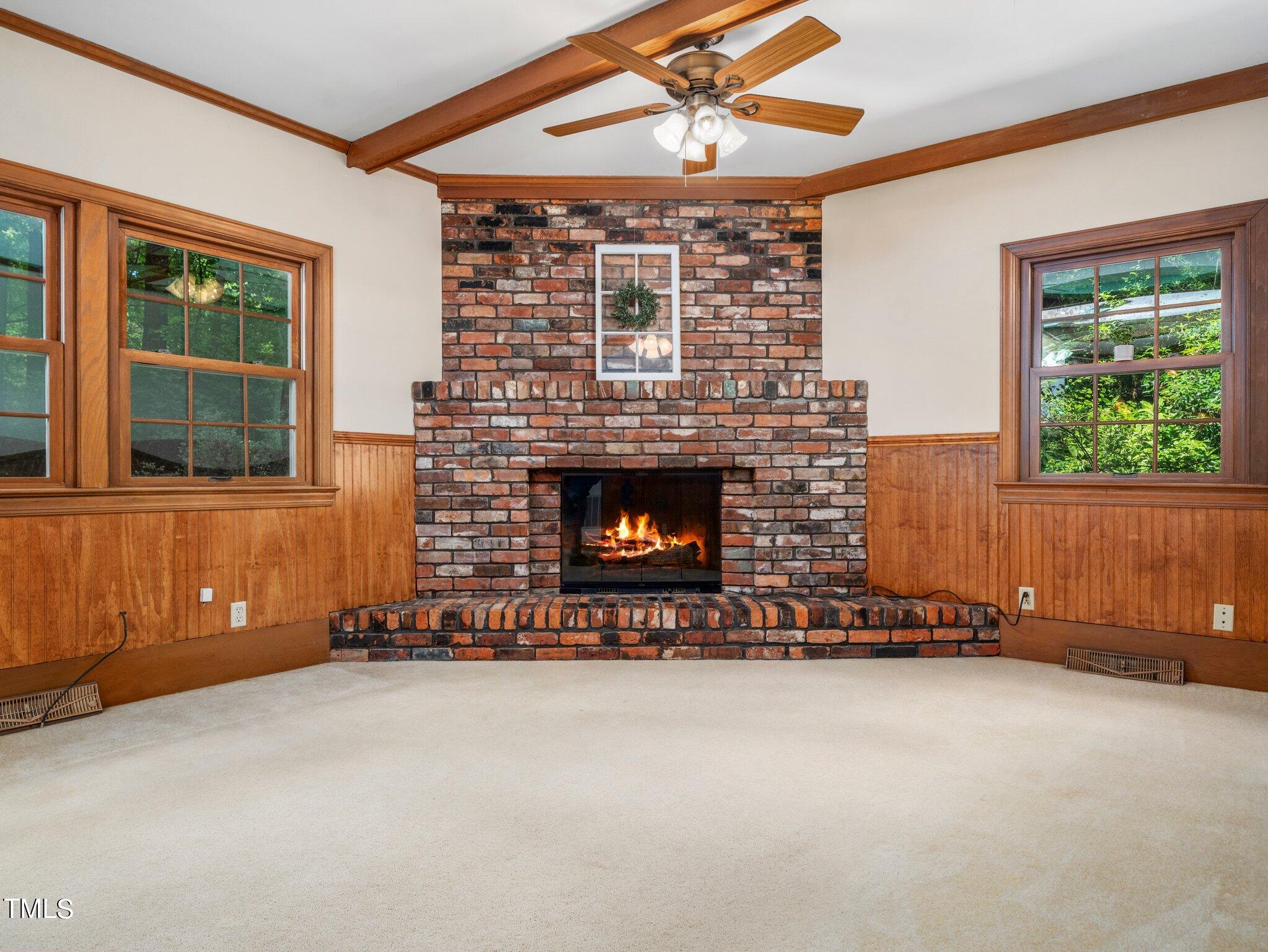 4205 Weaver Drive Raleigh, NC 27612 - Photo 11 of 48 a view of an empty room with a fireplace and windows