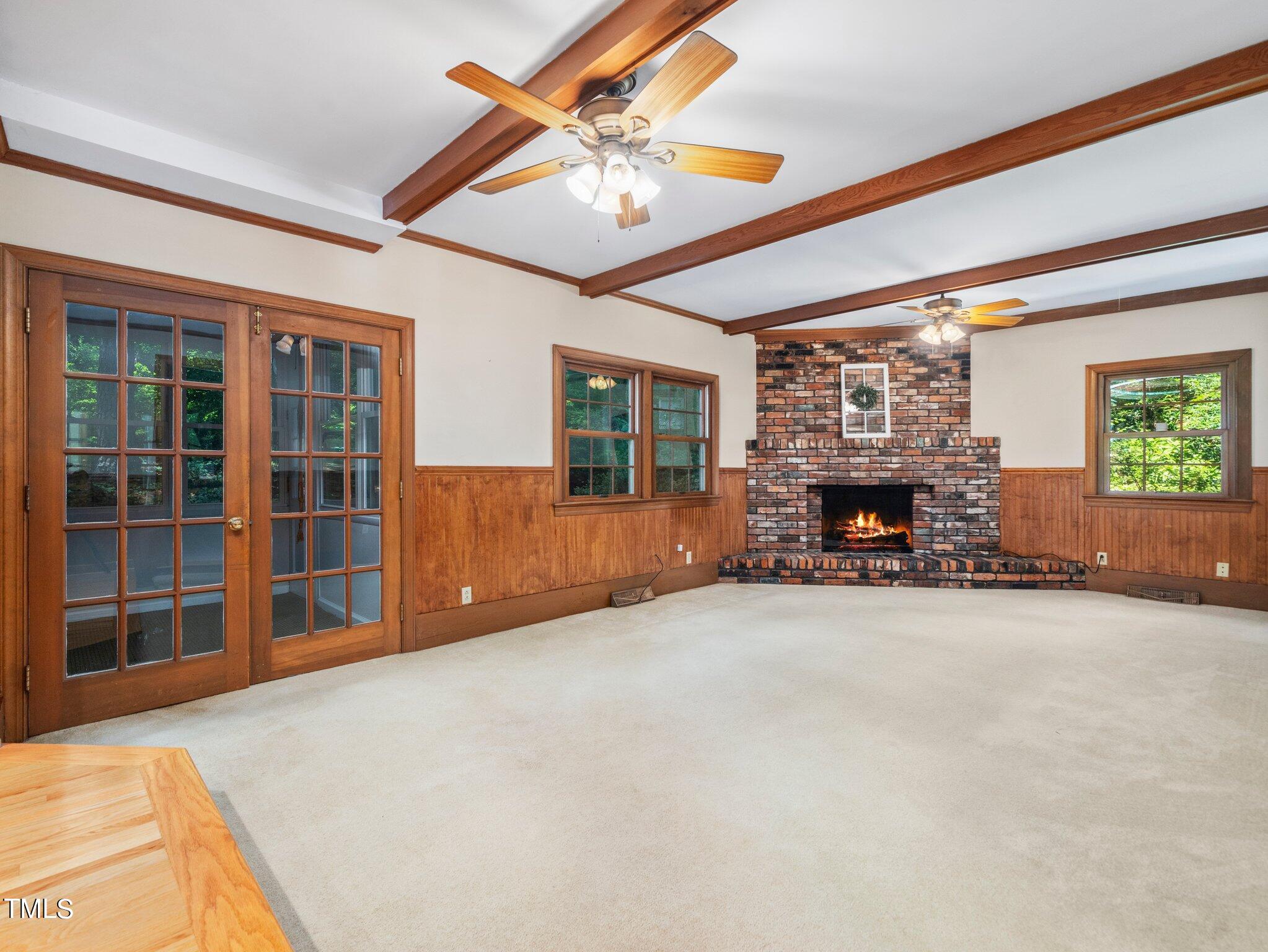 4205 Weaver Drive Raleigh, NC 27612 - Photo 12 of 48 a view of an empty room with a fireplace and a window