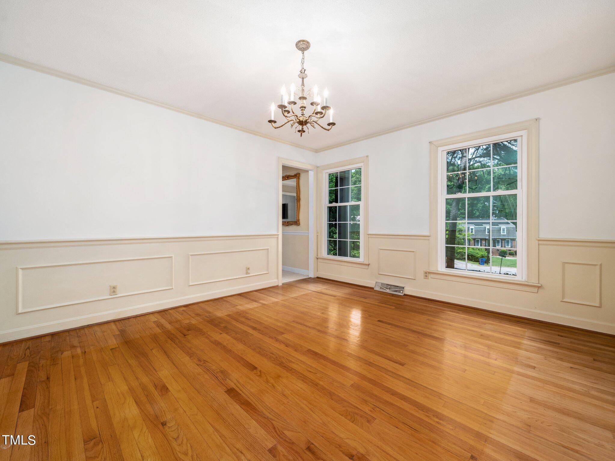 4205 Weaver Drive Raleigh, NC 27612 - Photo 18 of 48 a view of an empty room with wooden floor and a window