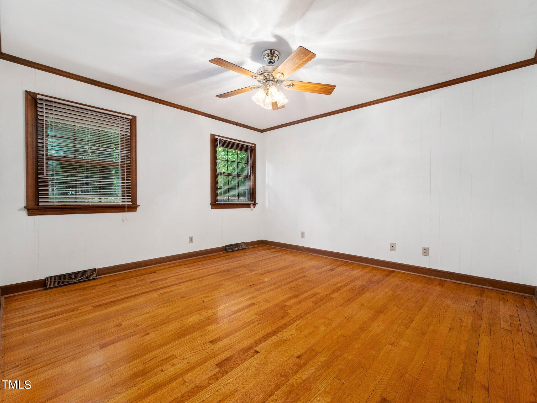 4205 Weaver Drive Raleigh, NC 27612 - Photo 20 of 48 a view of an empty room with window and wooden floor