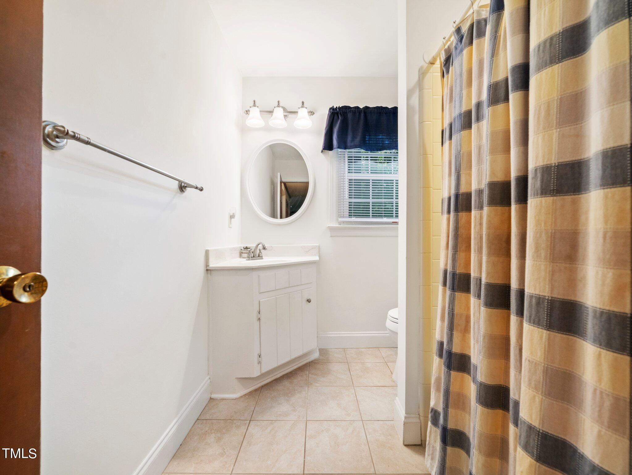 4205 Weaver Drive Raleigh, NC 27612 - Photo 22 of 48 a bathroom with a sink toilet and shower