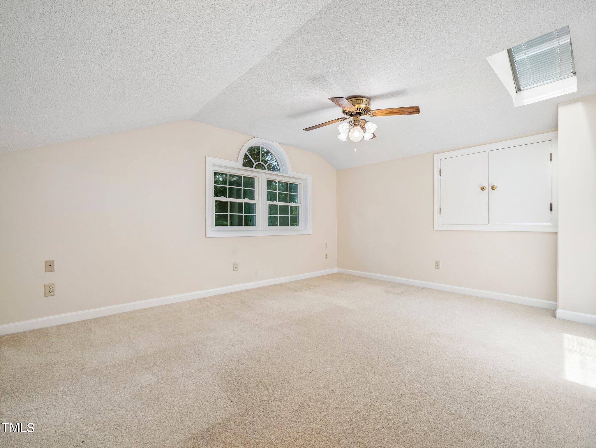 4205 Weaver Drive Raleigh, NC 27612 - Photo 24 of 48 an empty room with windows and ceiling fan