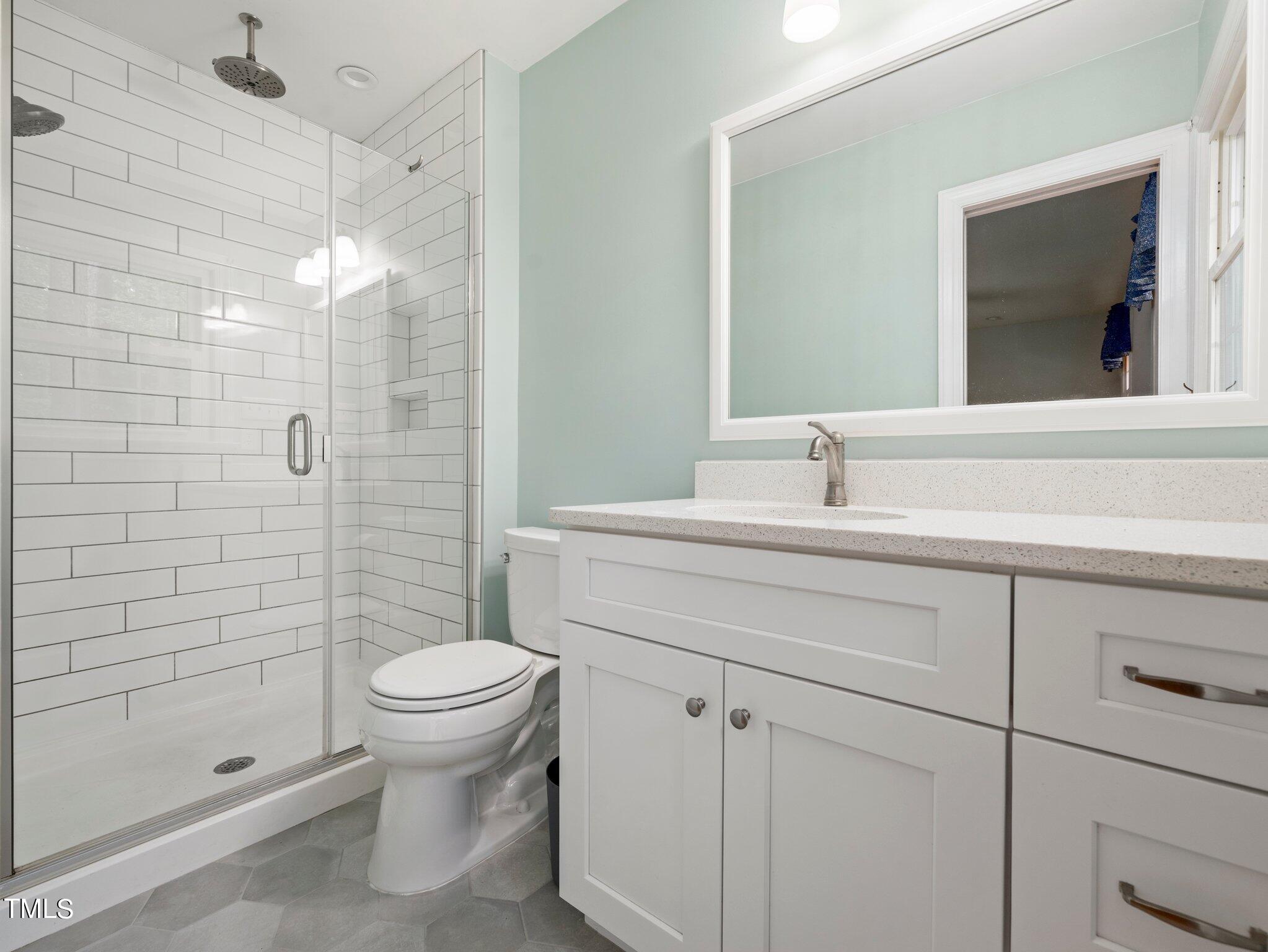 4205 Weaver Drive Raleigh, NC 27612 - Photo 31 of 48 a bathroom with a sink a toilet and shower