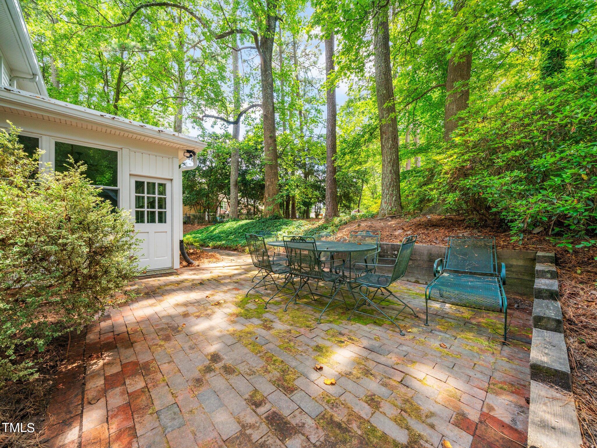 4205 Weaver Drive Raleigh, NC 27612 - Photo 36 of 48 a view of a yard with plants and a table and chair