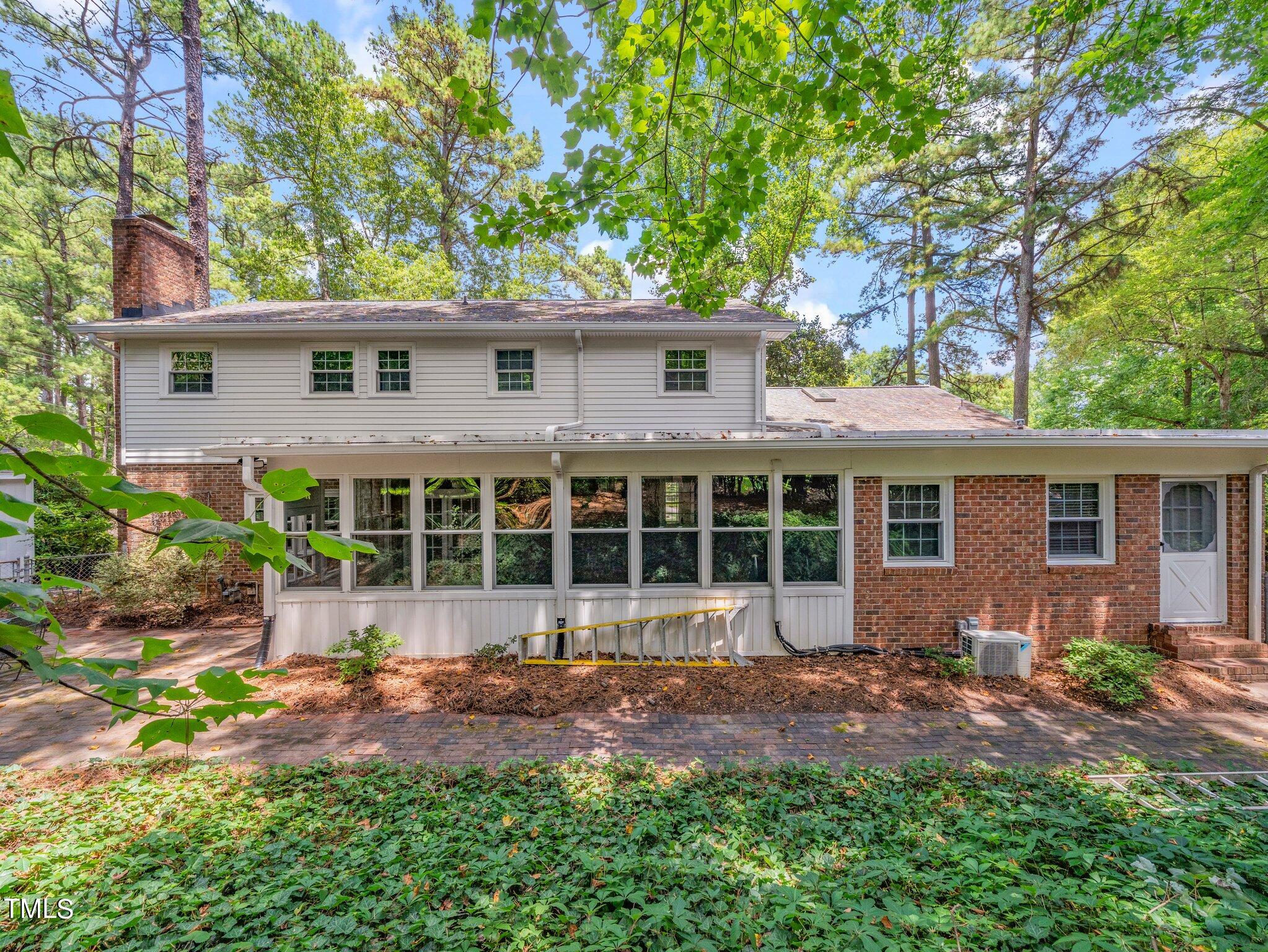4205 Weaver Drive Raleigh, NC 27612 - Photo 41 of 48 front view of a house with a yard and potted plants