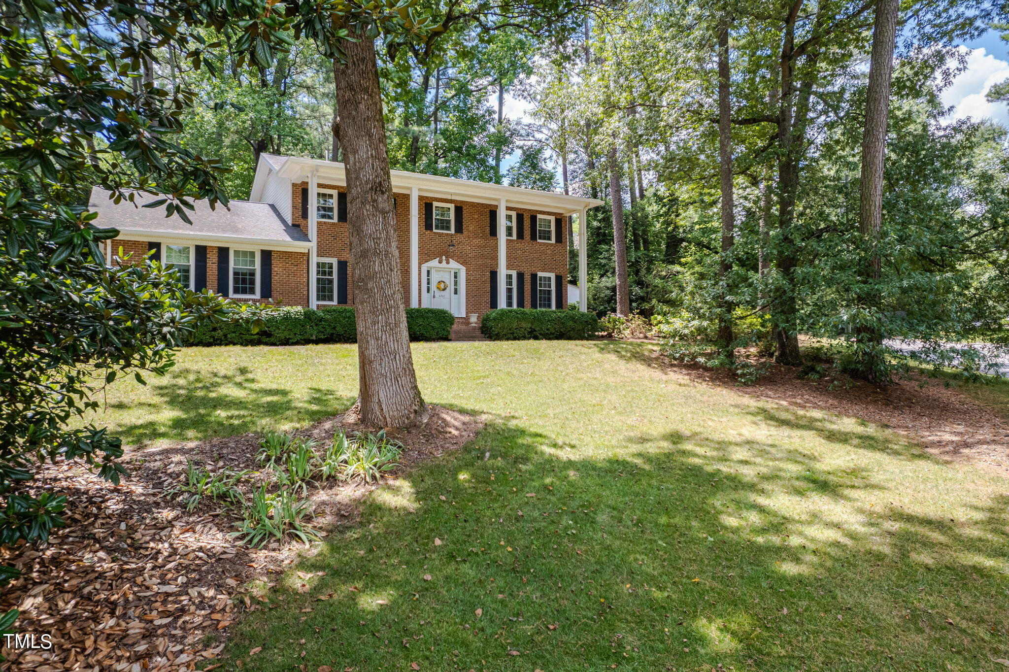4205 Weaver Drive Raleigh, NC 27612 - Photo 5 of 48 a front view of a house with a yard and trees