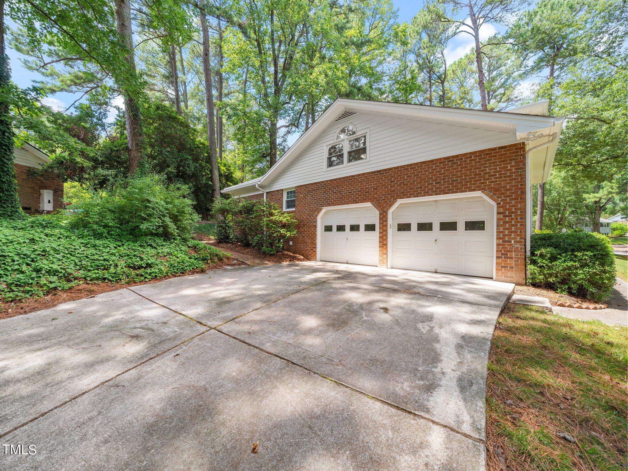 4205 Weaver Drive Raleigh, NC 27612 - Photo 6 of 48 a front view of a house with a yard and garage