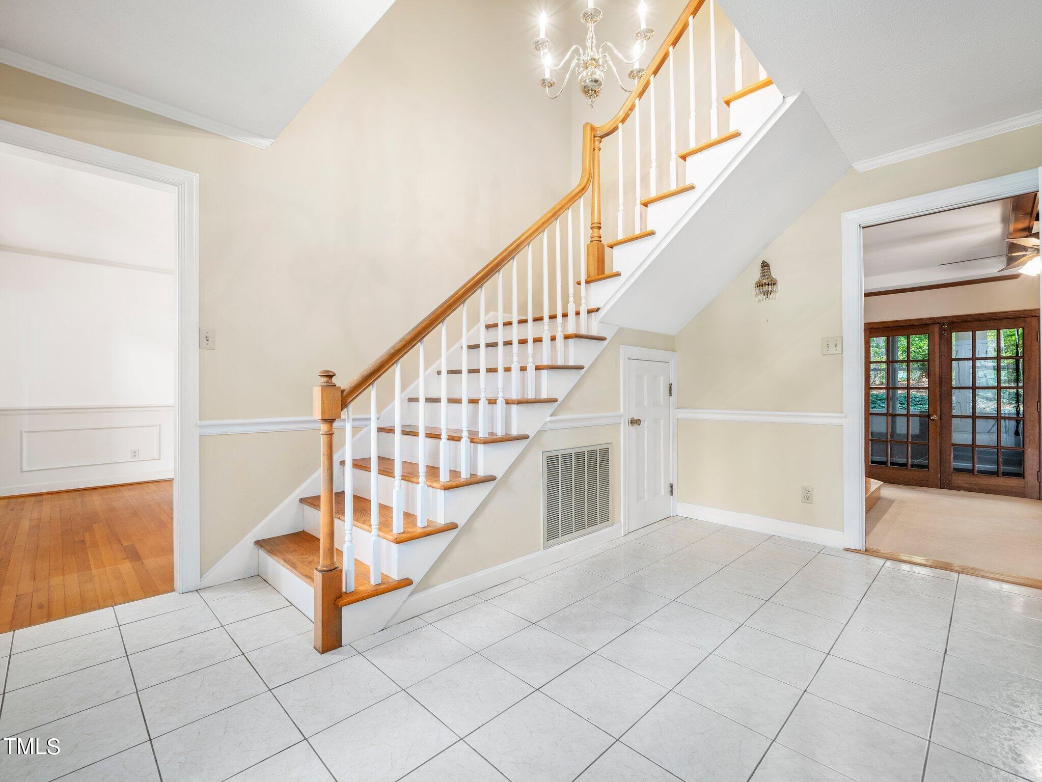 4205 Weaver Drive Raleigh, NC 27612 - Photo 8 of 48 a view of staircase with white walls and a large window