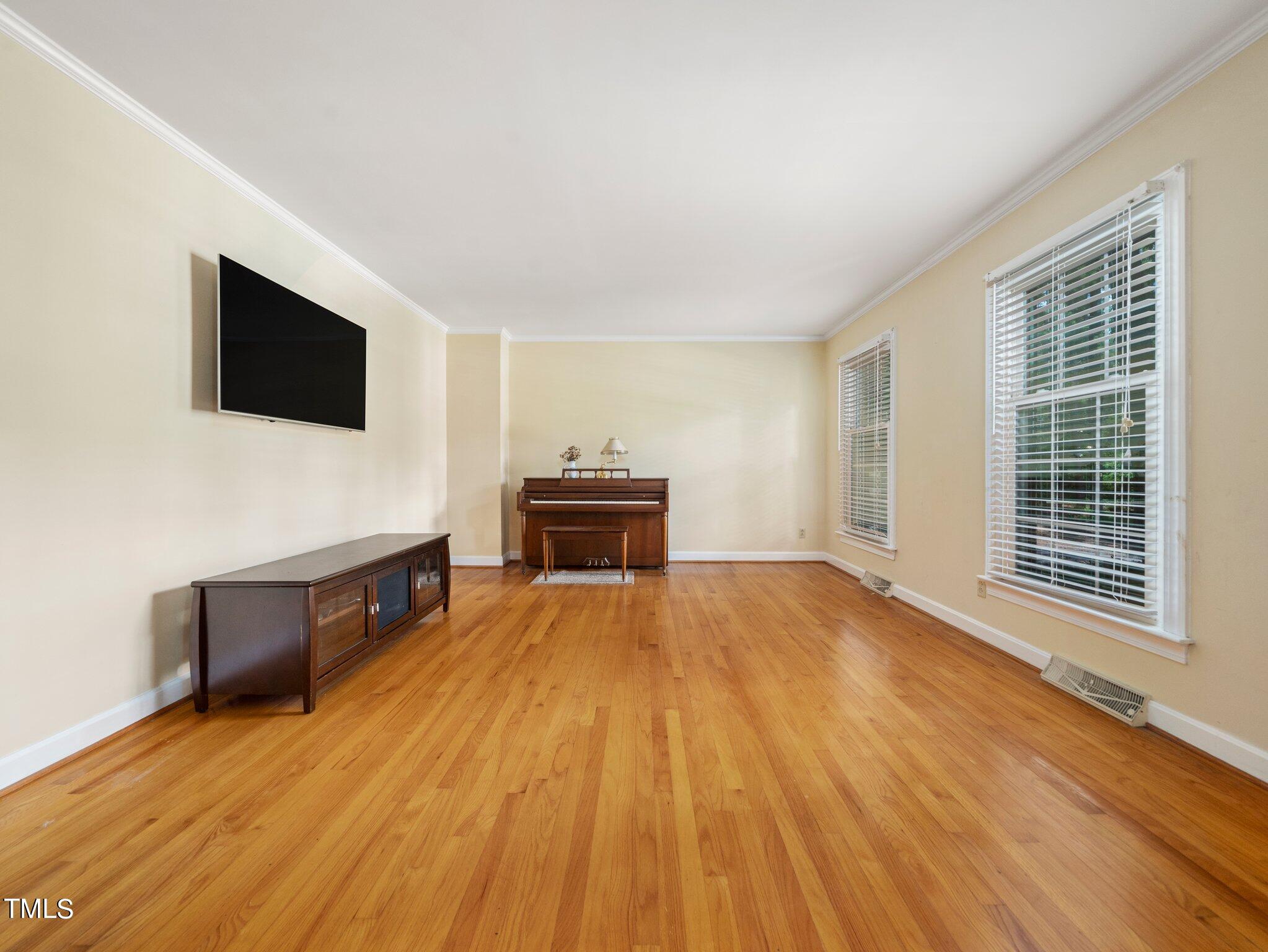 4205 Weaver Drive Raleigh, NC 27612 - Photo 9 of 48 a living room with furniture and a flat screen tv