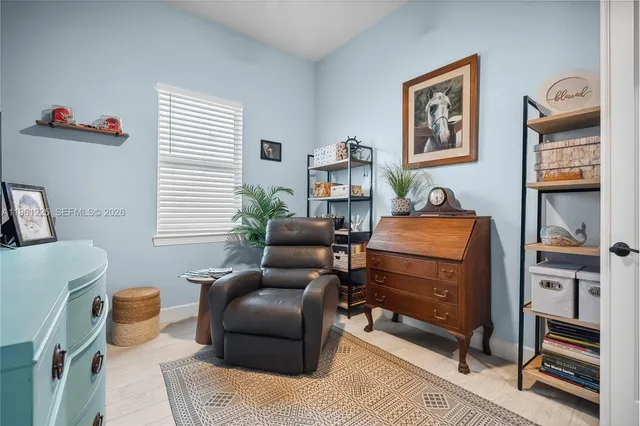 a bedroom with furniture and a window