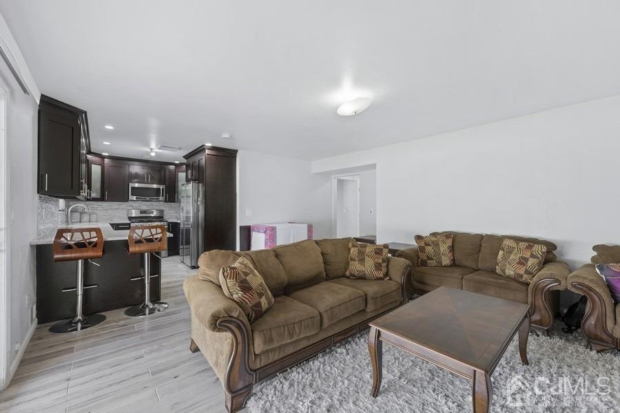 89 Normandy Drive Piscataway, NJ 08854 - Photo 12 of 20 a living room with stainless steel appliances furniture and a view of kitchen