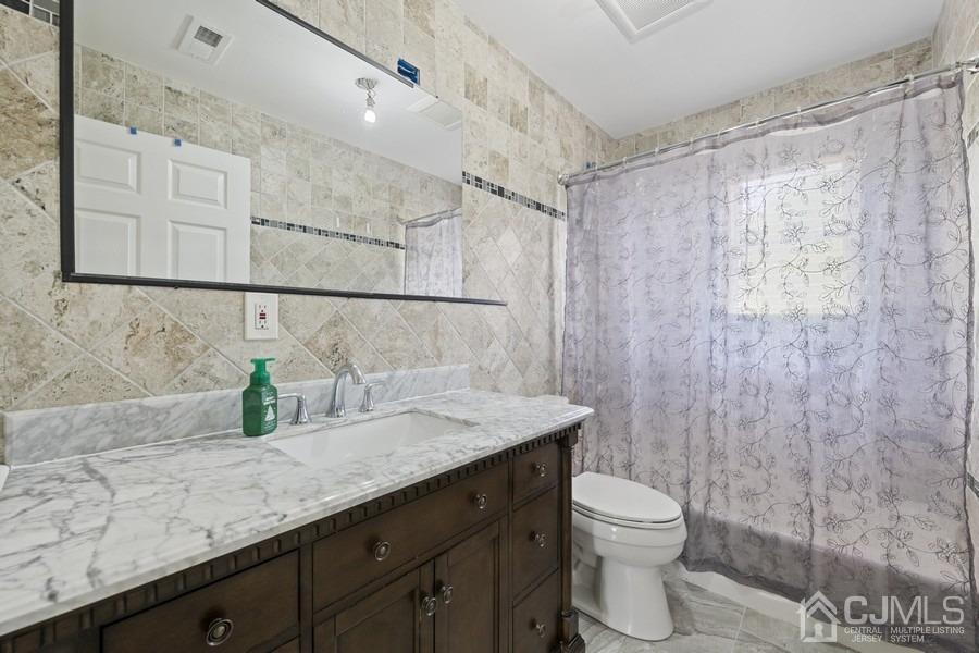 89 Normandy Drive Piscataway, NJ 08854 - Photo 15 of 20 a bathroom with a granite countertop sink a toilet and shower