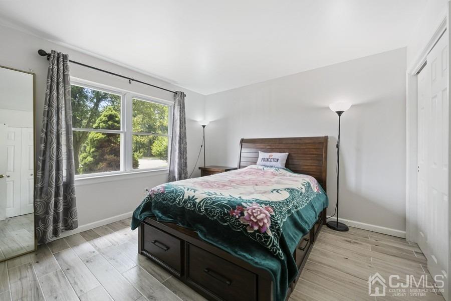 89 Normandy Drive Piscataway, NJ 08854 - Photo 16 of 20 a bedroom with a bed a window and wooden floor