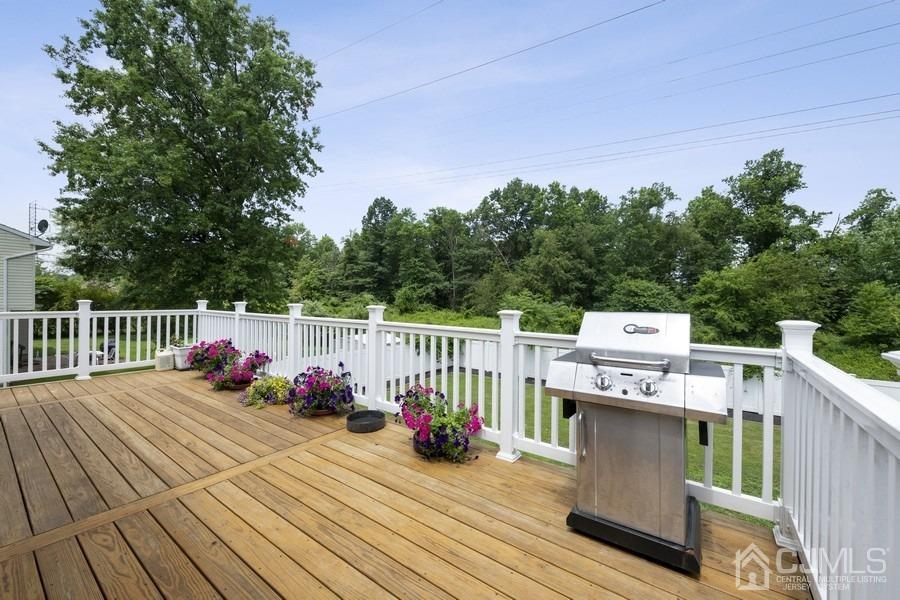 89 Normandy Drive Piscataway, NJ 08854 - Photo 19 of 20 a view of a deck with wooden floor and barbeque oven