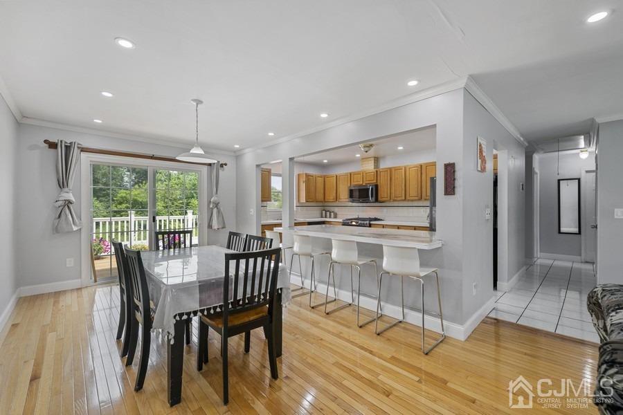 89 Normandy Drive Piscataway, NJ 08854 - Photo 4 of 20 a view of a dining room with furniture and wooden floor