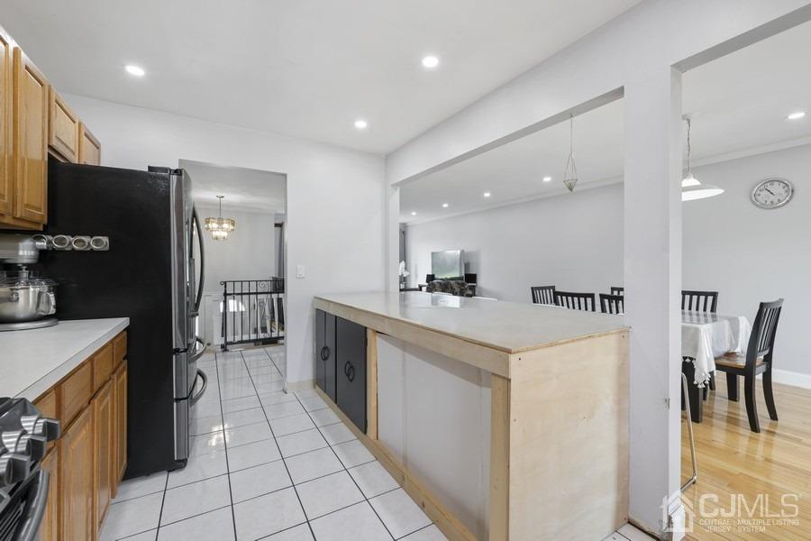 89 Normandy Drive Piscataway, NJ 08854 - Photo 5 of 20 a kitchen with a sink a refrigerator and a stove top oven