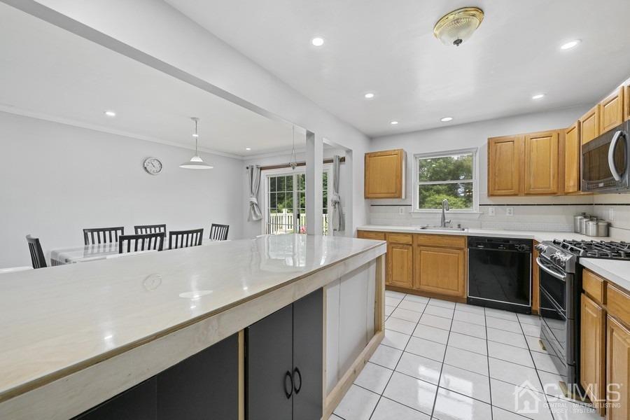 89 Normandy Drive Piscataway, NJ 08854 - Photo 6 of 20 a large kitchen with stainless steel appliances granite countertop a sink and cabinets