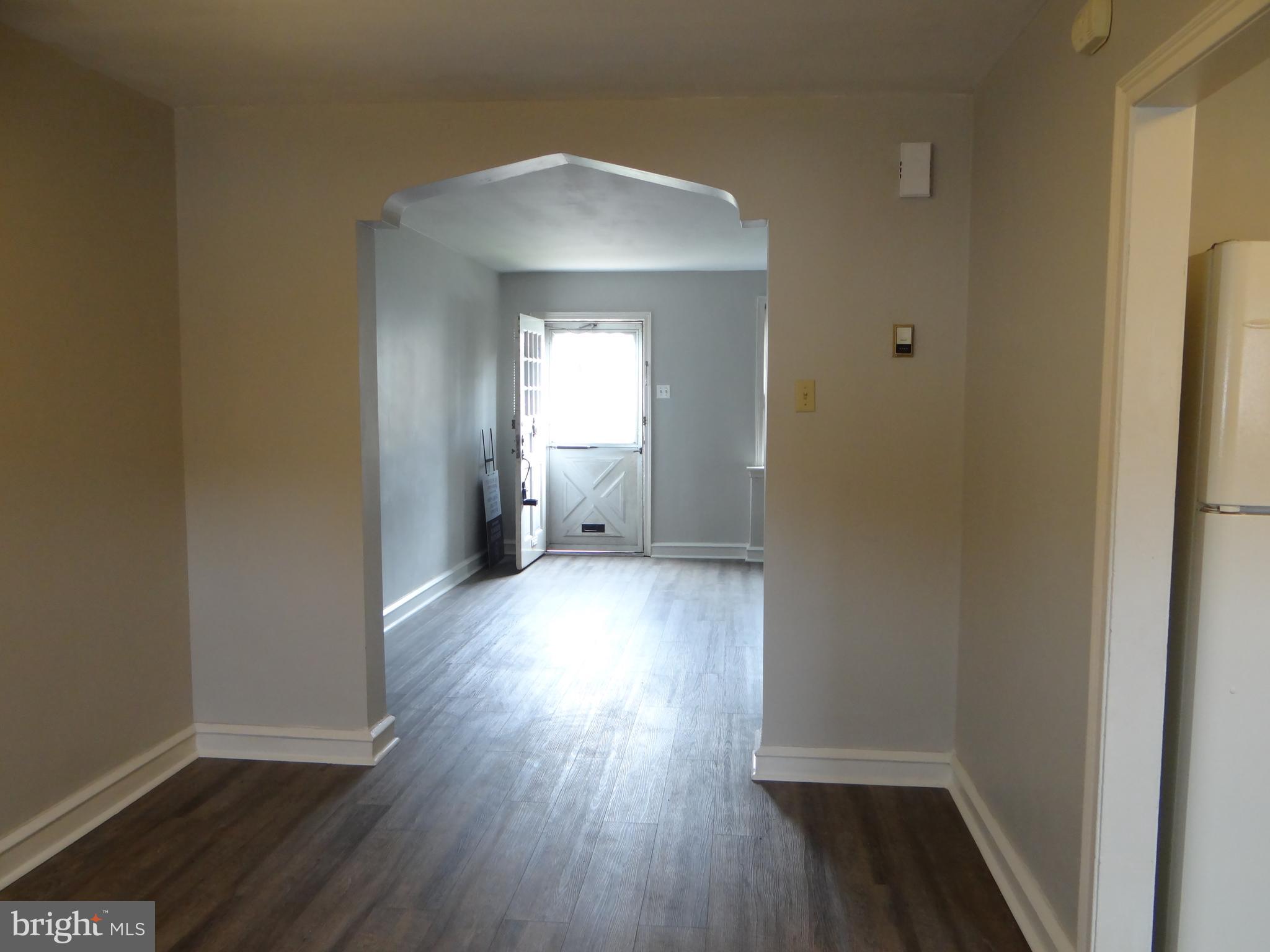 6744 Rutland Street Philadelphia, PA 19149 - Photo 12 of 44 a view of a hallway with wooden floor and a window