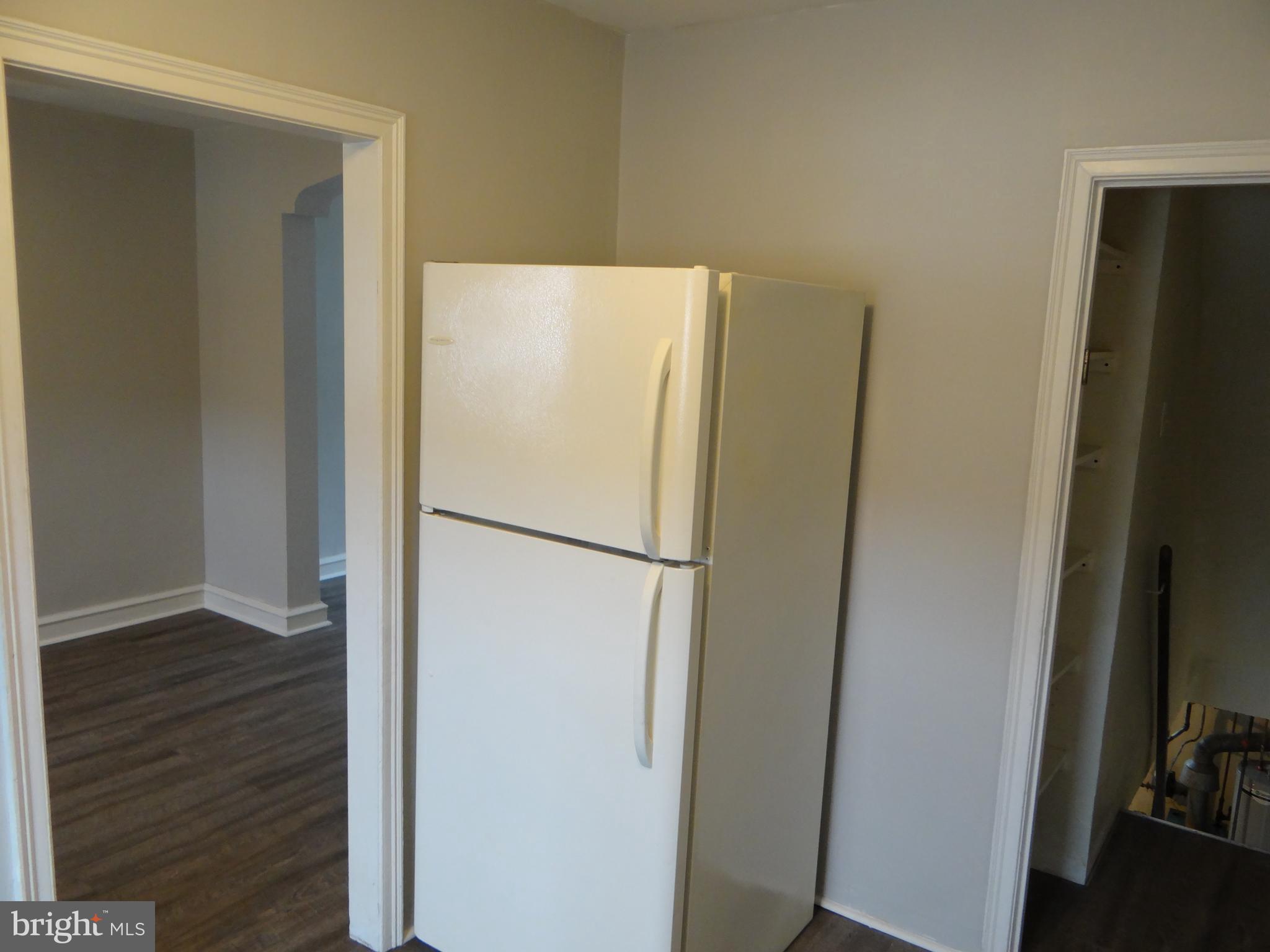 6744 Rutland Street Philadelphia, PA 19149 - Photo 17 of 44 a white refrigerator freezer sitting in a kitchen